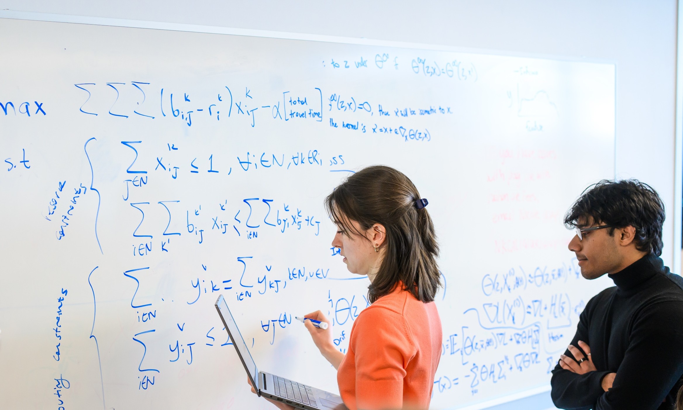&Ouml;zge and Arjun developing models at the whiteboard