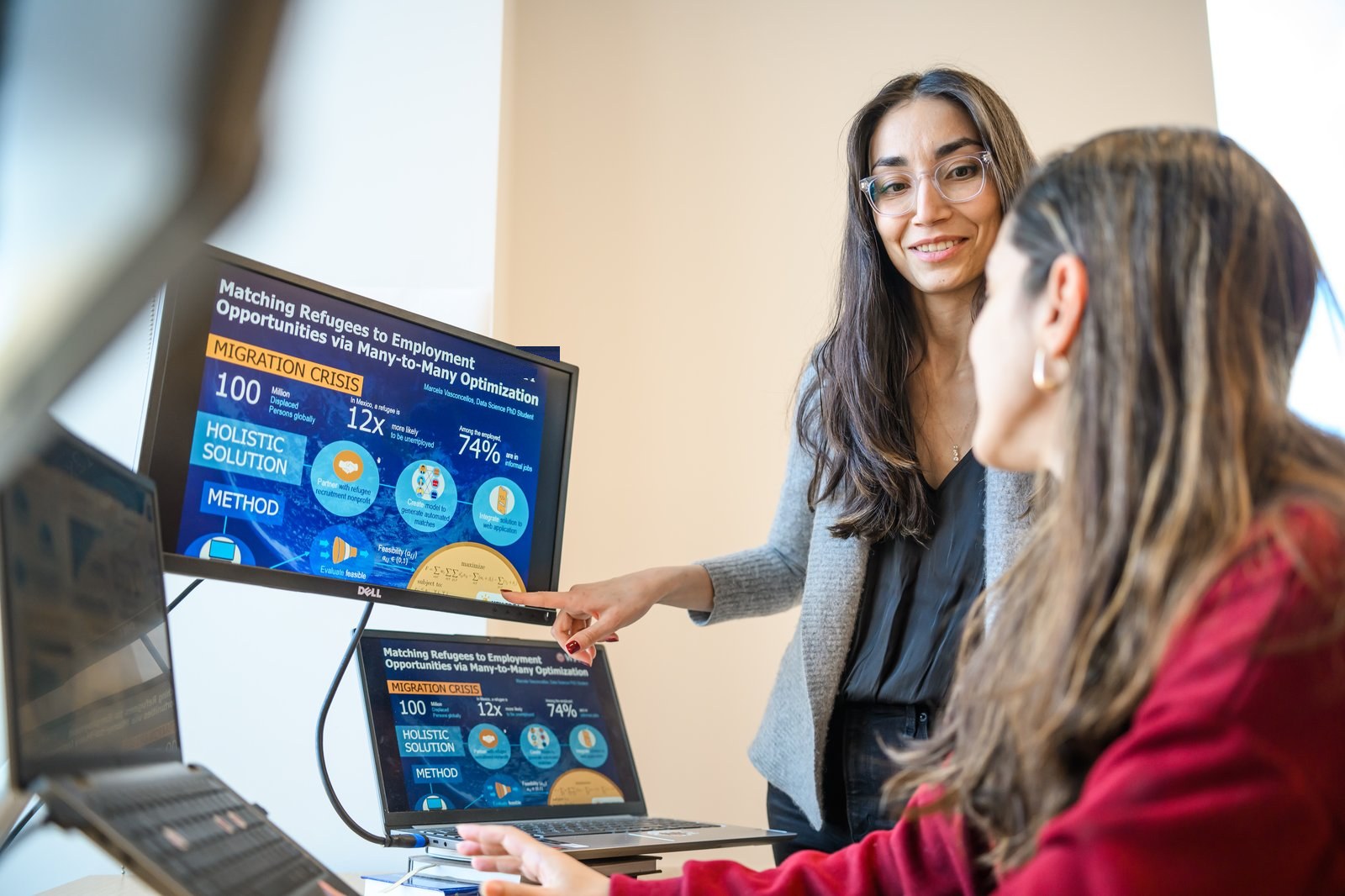 Researchers reviewing a refugee-to-employment matching dashboard